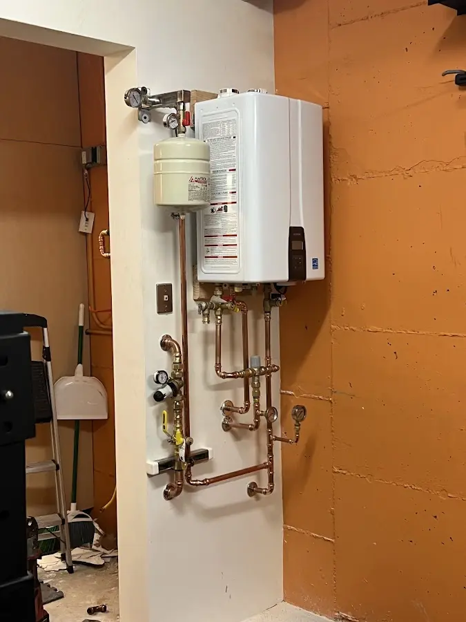 Plumbing technician inspecting water heater connections in Santa Rosa